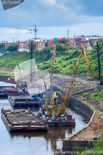 Image of Floating cranes and pile driving machine on barge