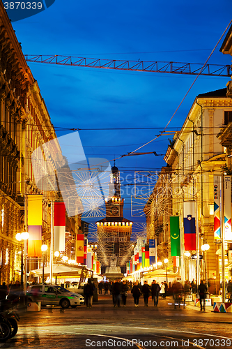 Image of Via Dante shopping street with people at night