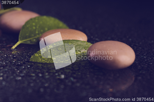 Image of zen stones on black with water drops