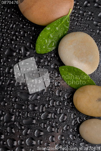 Image of zen stones on black with water drops