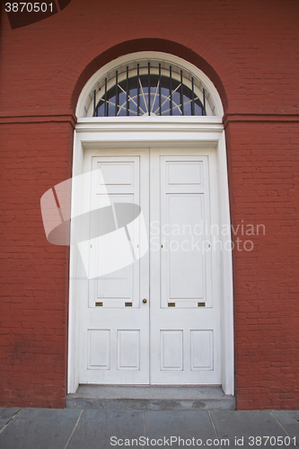 Image of White door, red building