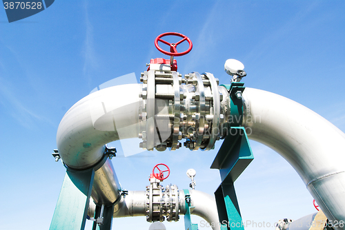 Image of Industrial zone, Steel pipelines and valves against blue sky