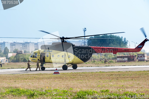 Image of Rescuers load into helicopter MI-8 