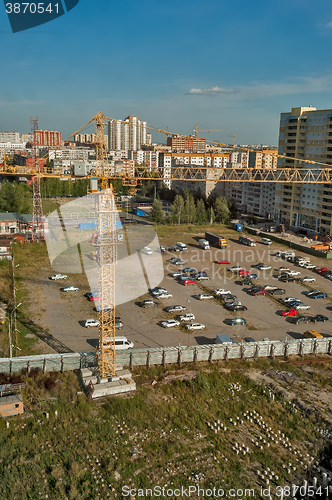 Image of Crane on construction site and parking lot