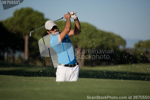 Image of pro golfer hitting a sand bunker shot