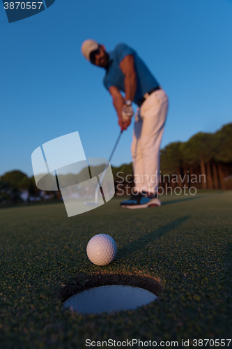 Image of golfer  hitting shot at golf course