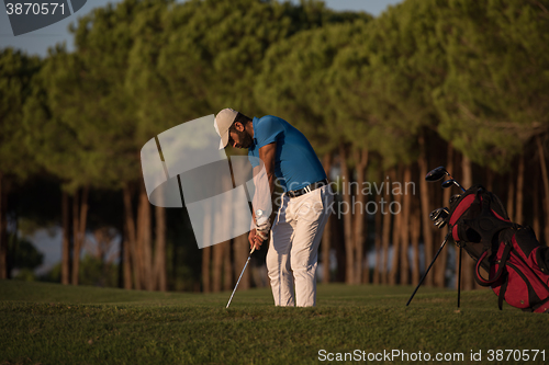 Image of golfer hitting a sand bunker shot on sunset