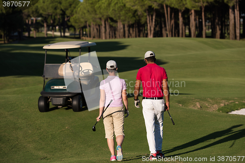 Image of couple walking on golf course