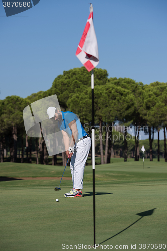 Image of golf player hitting shot at sunny day