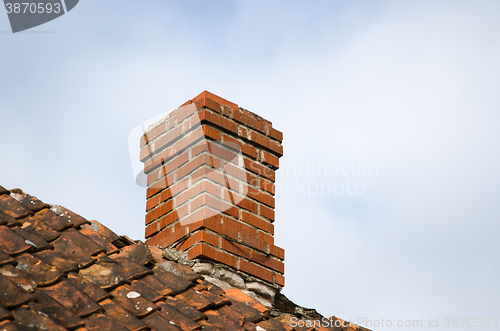 Image of Red chimney at an old rooftop