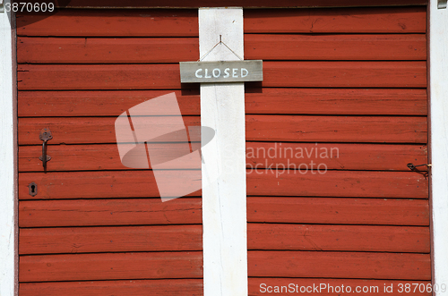 Image of Closed sign at two red doors