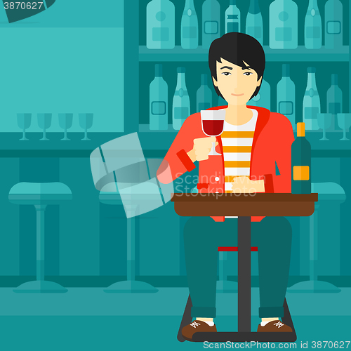 Image of Man sitting at bar.