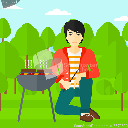 Image of Man preparing barbecue.