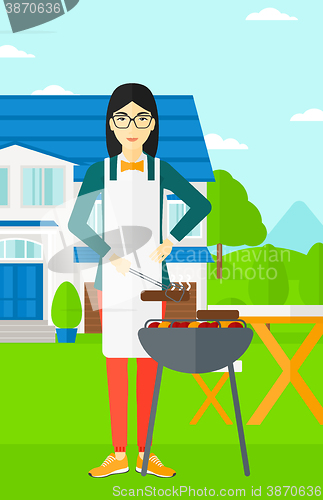 Image of Woman preparing barbecue.