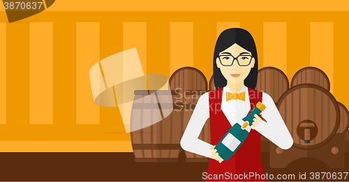 Image of Waitress holding bottle of wine.