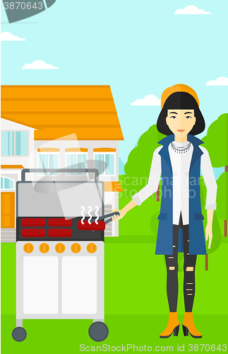 Image of Woman preparing barbecue.