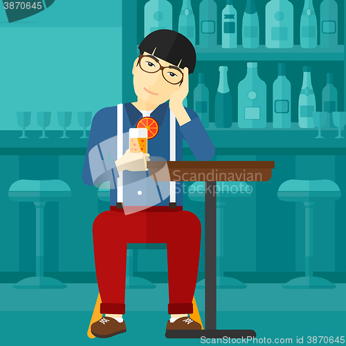 Image of Man sitting at bar.