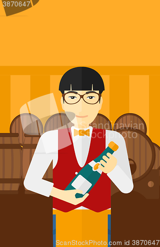 Image of Waiter holding bottle of wine.