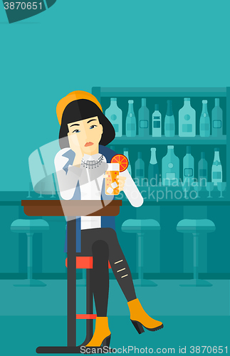 Image of Woman sitting at bar.