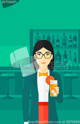 Image of Woman holding glass of juice.