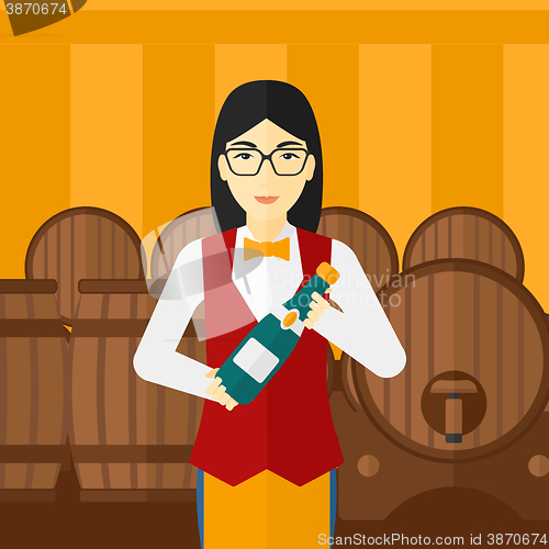 Image of Waitress holding bottle of wine.