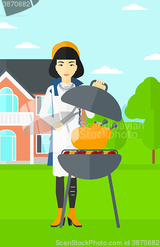 Image of Woman preparing barbecue.