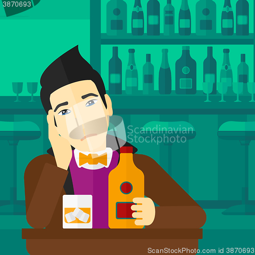 Image of Sad man with bottle and glass.