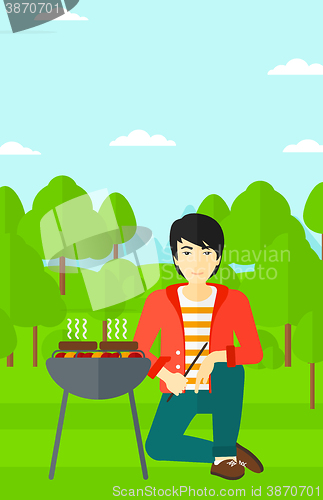 Image of Man preparing barbecue.