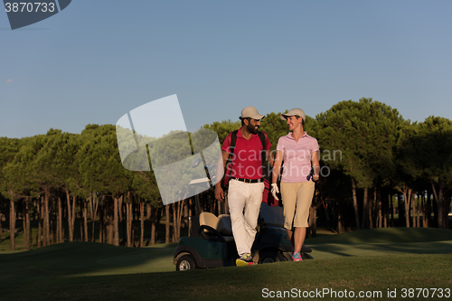 Image of couple walking on golf course