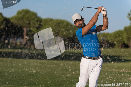 Image of pro golfer hitting a sand bunker shot