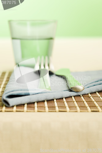 Image of Napkin on and the fork and spoon
