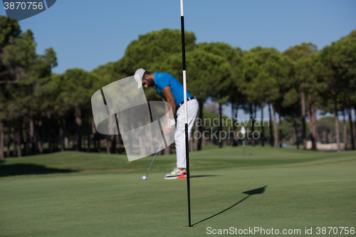 Image of golf player hitting shot at sunny day