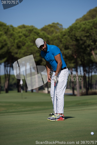 Image of golf player hitting shot at sunny day