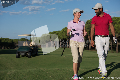 Image of couple walking on golf course