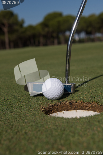 Image of hitting golf ball to hole