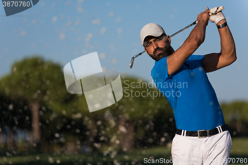 Image of pro golfer hitting a sand bunker shot