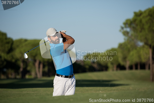 Image of pro golfer hitting a sand bunker shot