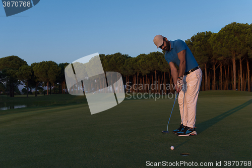 Image of golfer  hitting shot at golf course