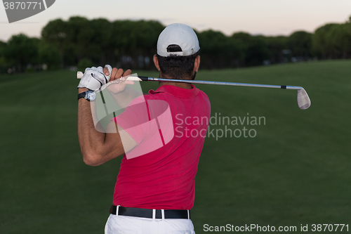 Image of golfer hitting a sand bunker shot on sunset