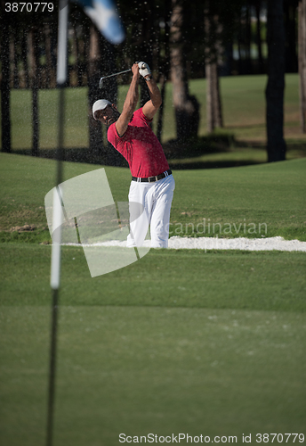 Image of golfer hitting a sand bunker shot