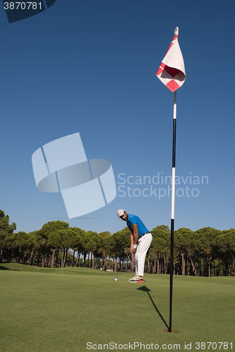 Image of golf player hitting shot at sunny day