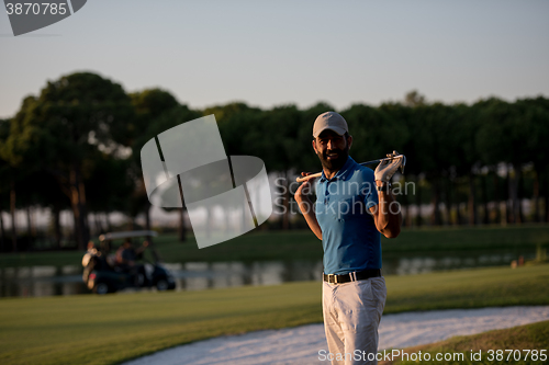 Image of golfer  portrait at golf course on sunset