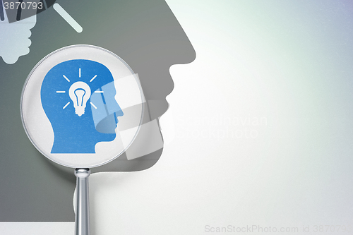 Image of Learning concept:  Head With Light Bulb with optical glass on digital background