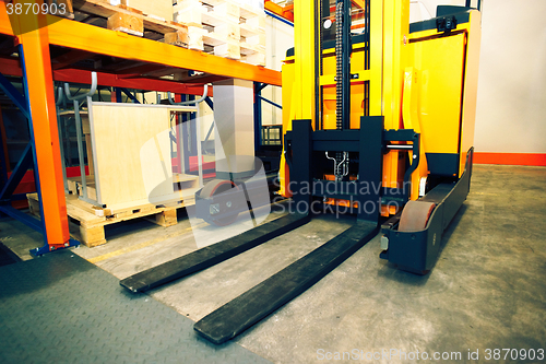Image of Shelves, racks and forklift  with pallets in distribution wareho