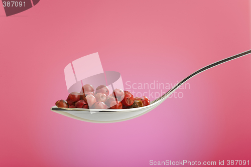 Image of spoon filled with rose peppers