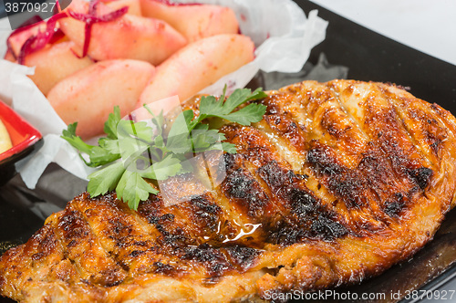 Image of plate of grilled meat with fries