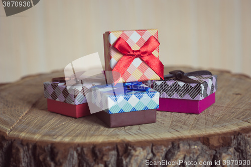 Image of Gift box with red bow on wood background