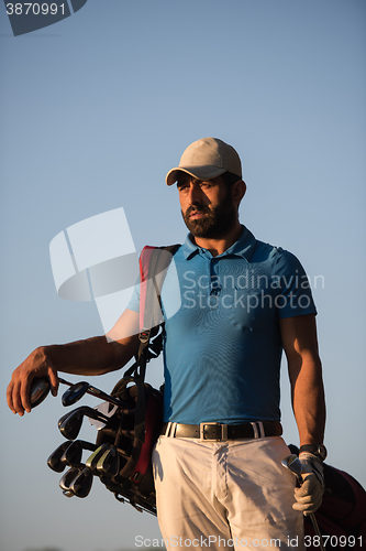 Image of golfer  portrait at golf course on sunset