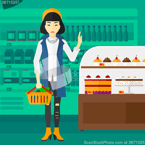 Image of Woman holding supermarket basket.