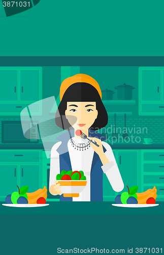 Image of Woman eating salad.